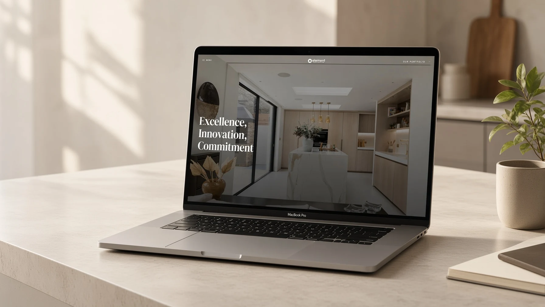 Element Construction homepage displayed on a laptop in a bright studio